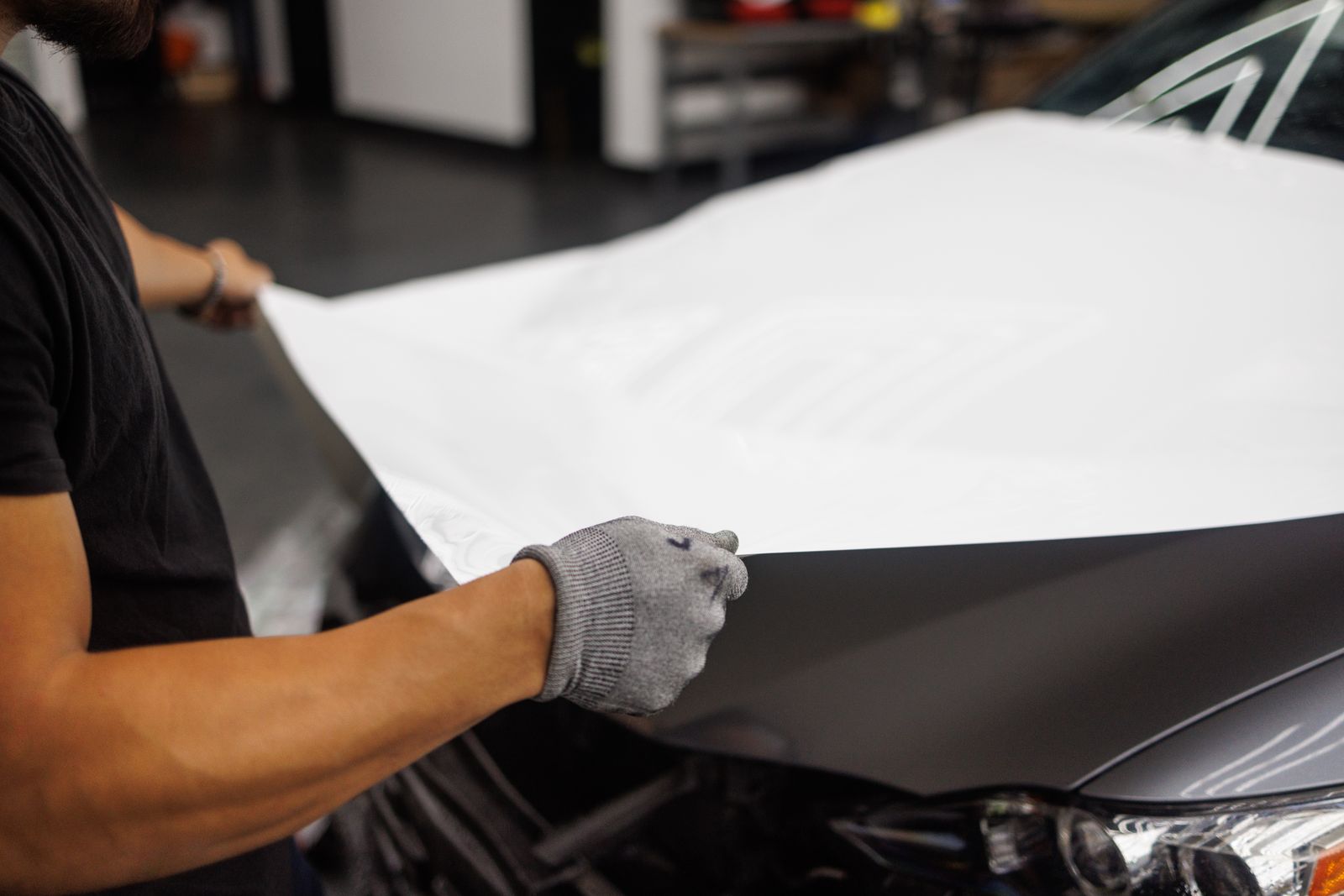 Installer applying vinyl wrap by hand
